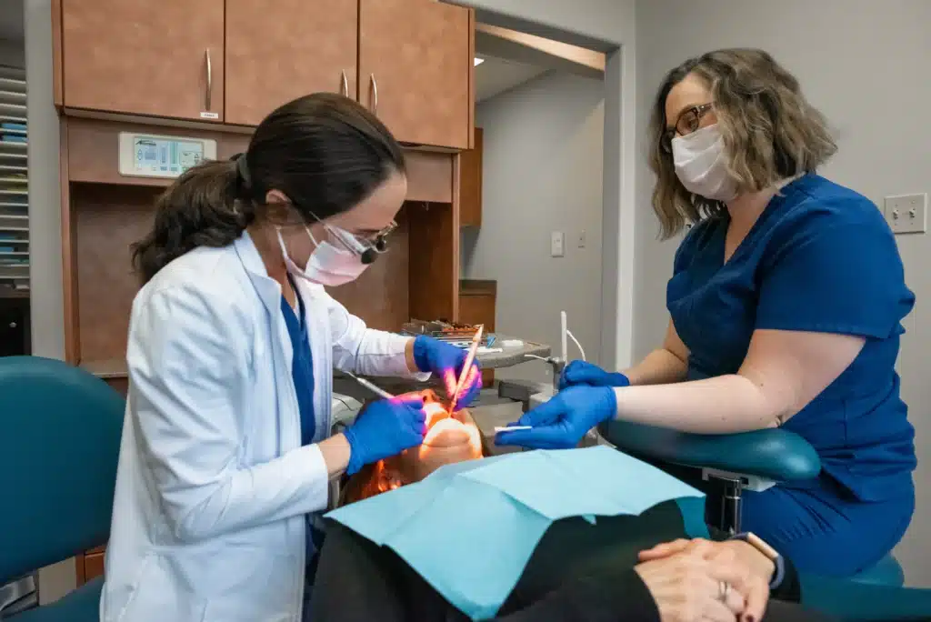 Dr. Richardson dpoing a tooth colored filling to a patient